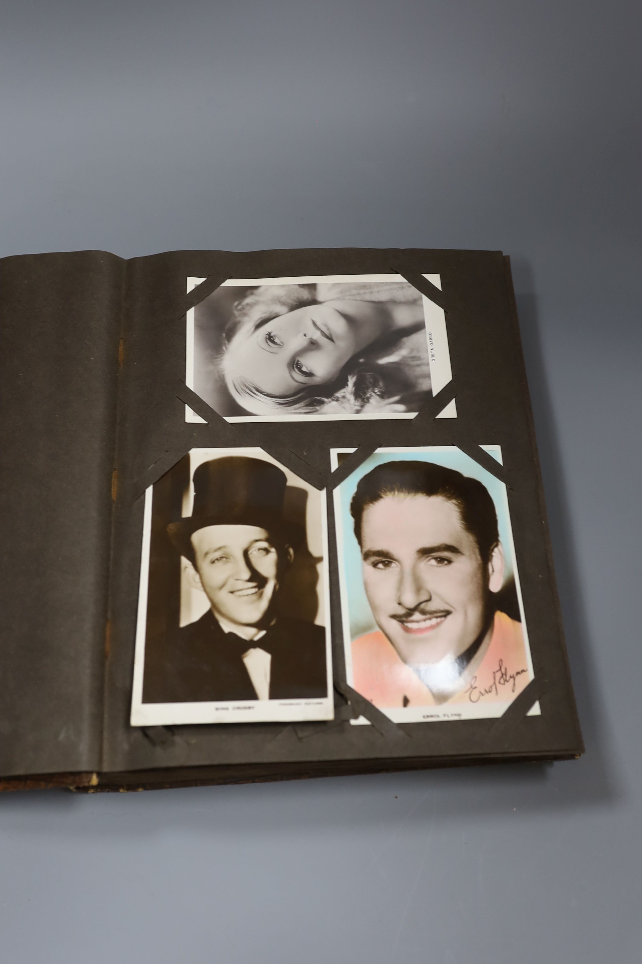 An album of approximately 160 early 20th century monochrome studio postcards including Garbo, Crosby, Gable and Hepburn.